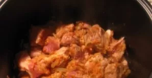 Add onions and carrots to the meat. Season with tomato paste and simmer together for 10 minutes.