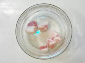 Thoroughly wash two 0.5-liter jars and sterilize over the steam for 5 minutes. Boil iron lids for 3 minutes. Put some of the fat In jars.