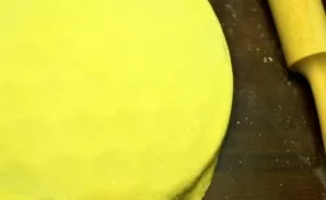 Take a portion of the dough and roll out a round pancake. The dough should be thin enough, but in no case full of holes. Put a pancake fr...