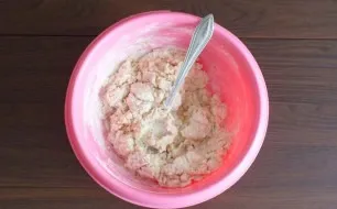 Start kneading with a spoon. As soon as the dough starts to form lumps, knead it with your hands until it is smooth.