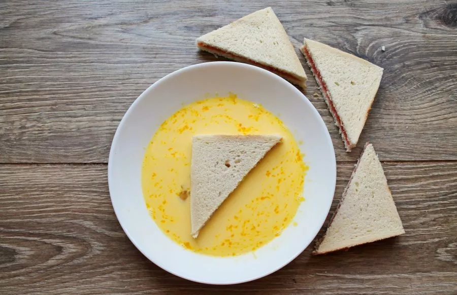 Dip each toast on both sides in the egg mixture to soak.