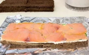 If you bought salmon uncut, cut it into thin slices. Then put on a layer of cucumbers.