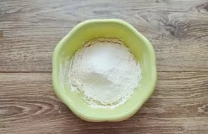 Mix the flour with the baking powder and add it to the mixing bowl. Mix until a smooth dough, it should be like thick sour cream.