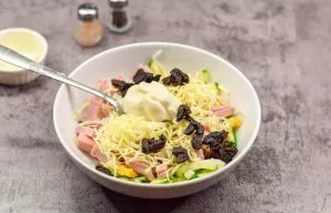 Season the salad with mayonnaise, add salt and pepper to taste. Also, be sure to add prunes cut into small pieces.