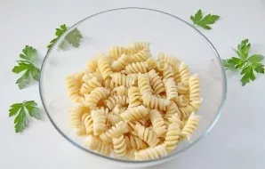Boil the pasta according to the instructions on the package, drain in a colander, then shake into a deep bowl.