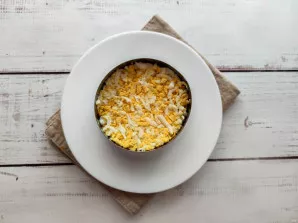 Put a grated egg on top of the onion.