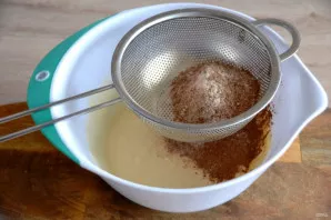 Sift the flour and cocoa mixture into the dough in batches, mixing each batch.