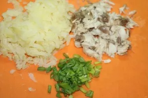 Grate the potatoes on a coarse grater, chop the onion, cut the mackerel into cubes.