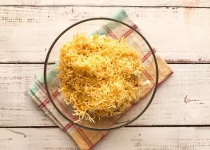 Grate the cheese on a fine grater.