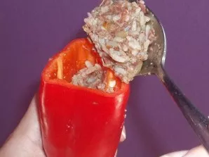 Stuff each bell pepper with the prepared meat filling.