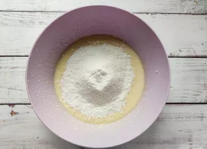 Add sifted flour and baking soda and mix well again.