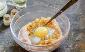 Break an egg into a bowl and pour in the cream.