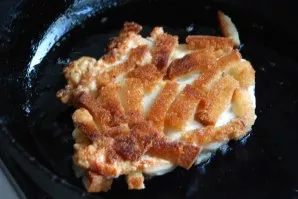 Fry the schnitzel on both sides until crispy and golden brown.