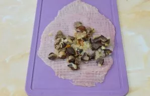 Put a mushroom filling on top of each sliced piece of meat.