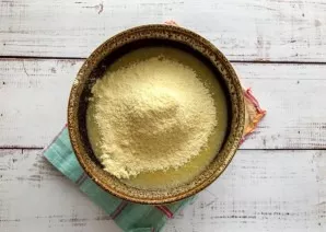 Add cornmeal and knead the dough.