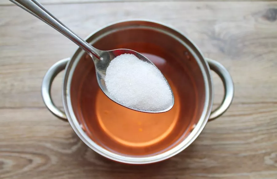 Pour the liquid from the jar into a pot, add sugar and bring to a boil.