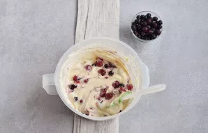 Add a glass of frozen berries to the dough. Mix it up.