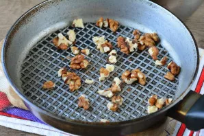 Lightly toast the walnuts in a pan.