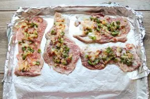 Lay out vegetables and bacon on top of the meat.