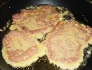 Dip the meatballs on both sides in the dough and put them in a pan. Fry them in vegetable oil over medium heat on both sides until nicely...