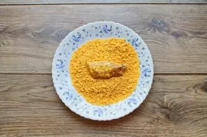 Crush the cornflakes into crumbs and roll nuggets in them.