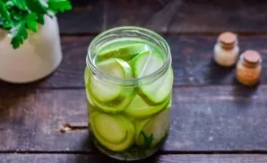 Pour zucchini with boiling water, cover the jar with a lid, leave for 10 minutes. After a while, drain the water, bring to a boil and ret...