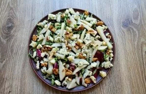 Mix vegetable oil and honey until smooth. Pour the mixture over the salad and toss.