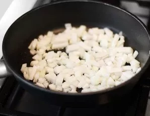 Heat vegetable oil in a pan and add diced onions. Fry over medium heat.