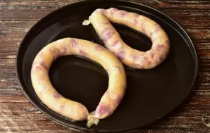 Place the sausage on the baking sheet.