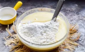 Add flour and baking powder, stir with a spoon.