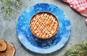 Grate the carrots on a coarse grater and put on top of the onion letters. Apply a mayonnaise mesh.