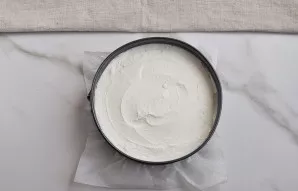 Pour the cottage cheese mixture into the baking dish on the cookie sheet. Shake the baking dish several times to remove excess air from t...