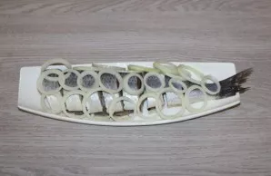 Cut the herring into pieces. Place the onion rings on top of the herring.