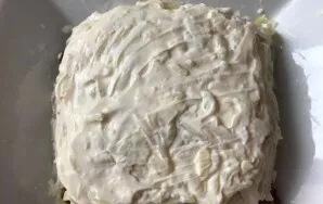 Then peel the eggs and grate them on a coarse grater. Put on a layer of pickled cucumbers and coat with mayonnaise.