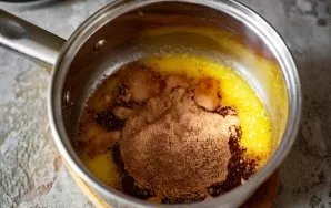 Pour a mixture of milk, cocoa and sugar into a saucepan with melted butter.