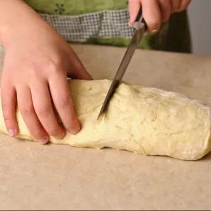 The dough should double in size by now. Cut the dough into 2 parts. The recipe will give you 2 pizzas.