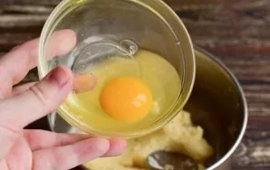 Let cool slightly and beat one egg at a time.
