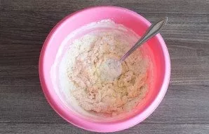 Start kneading the dough with a fork. As soon as the dough starts to form lumps, knead with your hands.