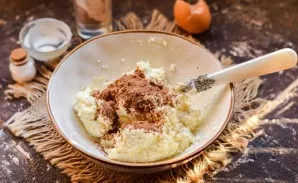 Divide the dough into two parts, add cocoa powder to one part and mix well.