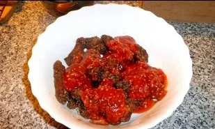 Transfer the baked wings to a saucer. Coat the top with sauce. Stir.