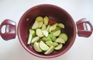 Then put chopped zucchini in a pan with onions and carrots.