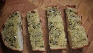 Let the bread cool slightly, cut into slices with a sharp knife and serve immediately.