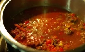 Then we shift the baking over the minced meat to the pot, put the tomatoes and pour the tomato paste. We add water. We put it on medium h...