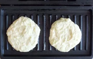 Heat a multipurpose pan. Grease the plates with a thin layer of vegetable oil. Spread 2 tablespoons of pancake batter on top. Make a roun...