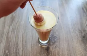 Pour the batter into a narrow, tall glass and dip the sausage into it. Take it out and let the excess batter drip off a little.