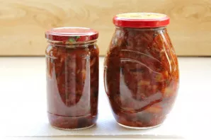 Pour vinegar into the mushrooms, stir and immediately put in sterilized jars. Turn the jars upside down and roll them up until completely...