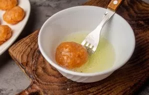 Dip each cutlet one by one in egg whites.