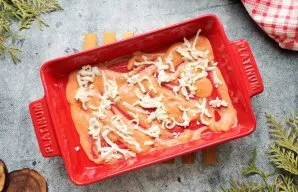 Grate the cheese on a coarse grater. Pour a little sauce on the bottom and sprinkle with cheese.