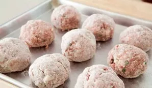 Roll each dumpling in flour, then put on a tray.