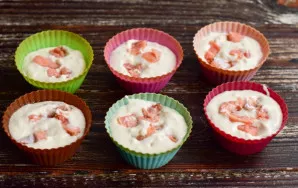 Cut the fish into small pieces and put it on top of the cupcakes.